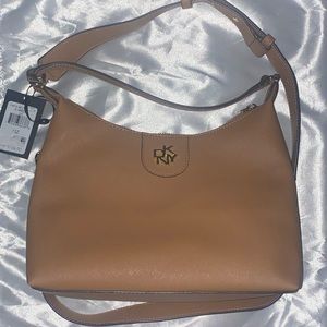Brand new with tags DKNY carol pouchette crossbody/handbag. Cashew color
